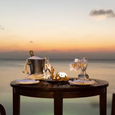 Anantara_Dhigu_Maldives_Resort_Guest_Room_Over_Water_Pool_Suite_Sunset_with_Cocktails_on_the_Table